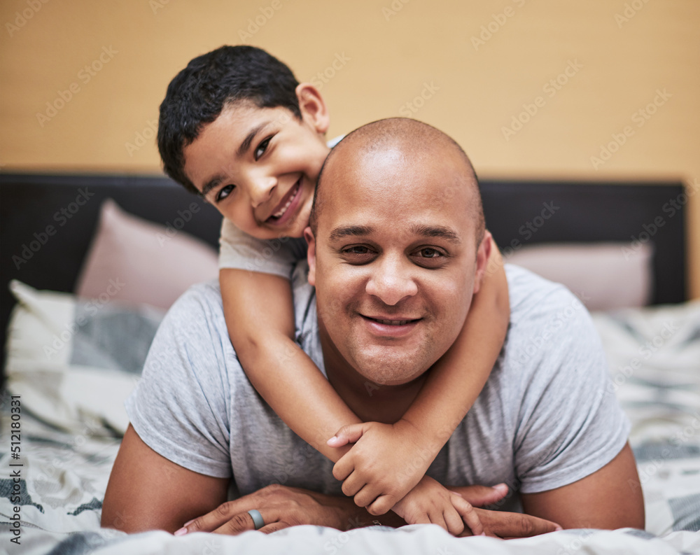 We got the place to ourselves today. Portrait of a cheerful little boy hanging on his fathers back while hanging out in the bedroom at home during the day. We got the place to ourselves today. Portrait of a cheerful little boy hanging on his fathers back while hanging out in the bedroom at home during the day.