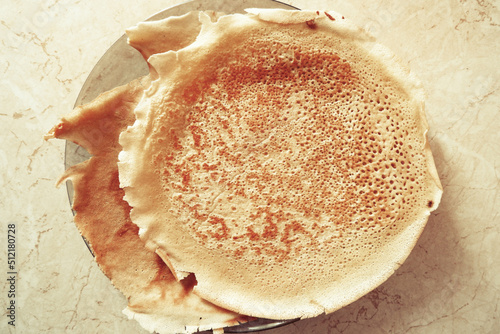 fried pancakes are on a plate, strawberry jam is on top