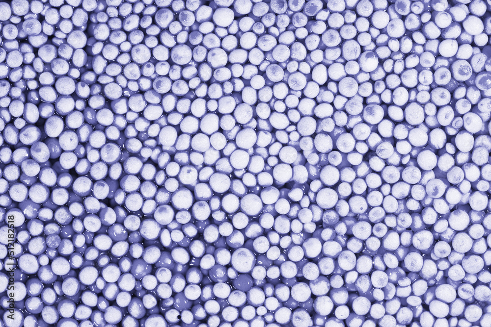 Beautiful background with mother-of-pearl pearls, top view.Violet and silver colors. Demonstrating color of 2022 year. Abstract texture for festive backgrounds. Shiny surface of Christmas decorations.