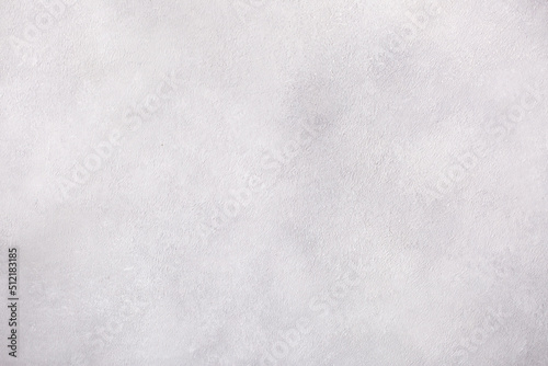 Light background of decorative plaster with abstract spots. Unusual texture of white or gray wall with beautiful patterns, creative surface background. Finishing coating for building cladding.