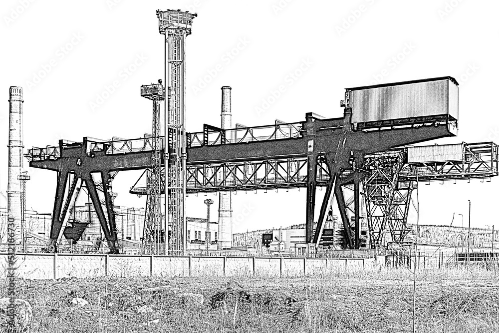 Obraz premium Gantry crane and factory chimneys