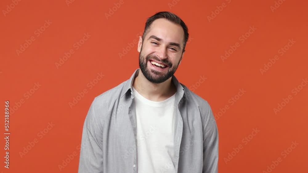Blithesome charismatic playful happy swanky young brunet man 20s years old wears blue shirt close eyes with hands play guess who or hide and seek isolated on plain orange background studio portrait Blithesome charismatic playful happy swanky young brunet man 20s years old wears blue shirt close eyes with hands play guess who or hide and seek isolated on plain orange background studio portrait