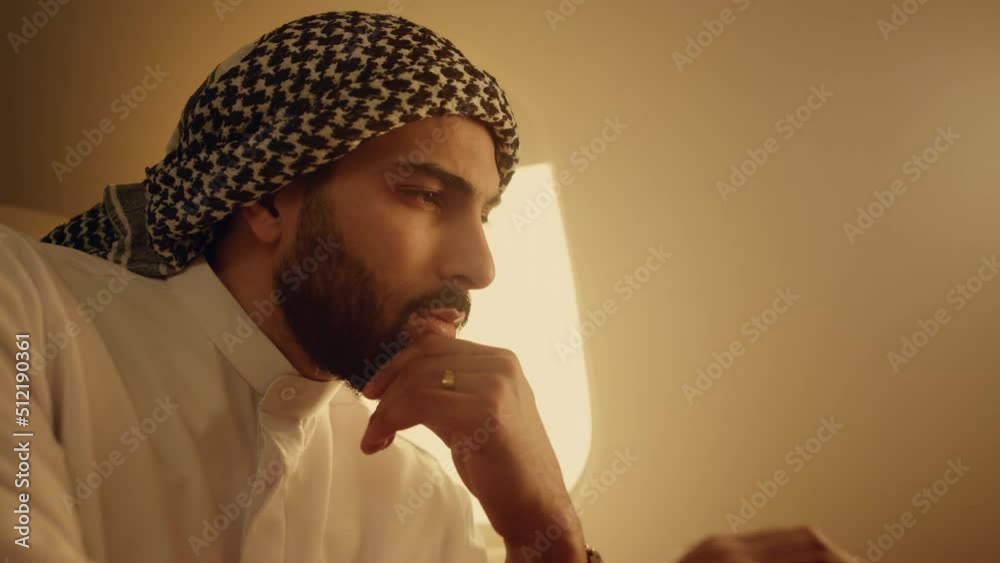Pensive ceo solving problem on business trip closeup. Focused arab typing laptop