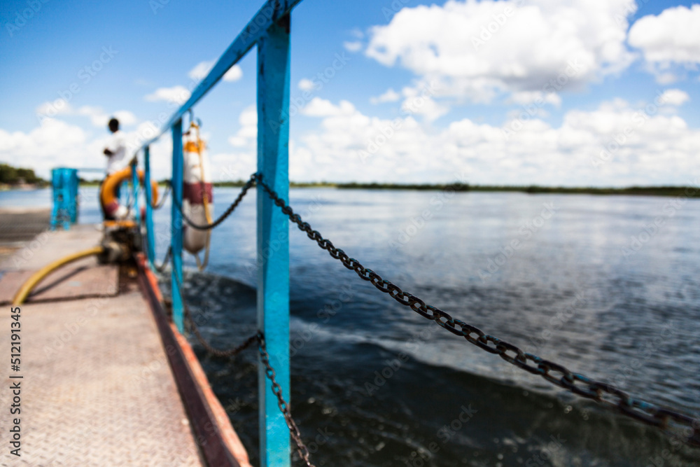 Lone figure in the distance on a vehicle barge crossing the river in Botswana