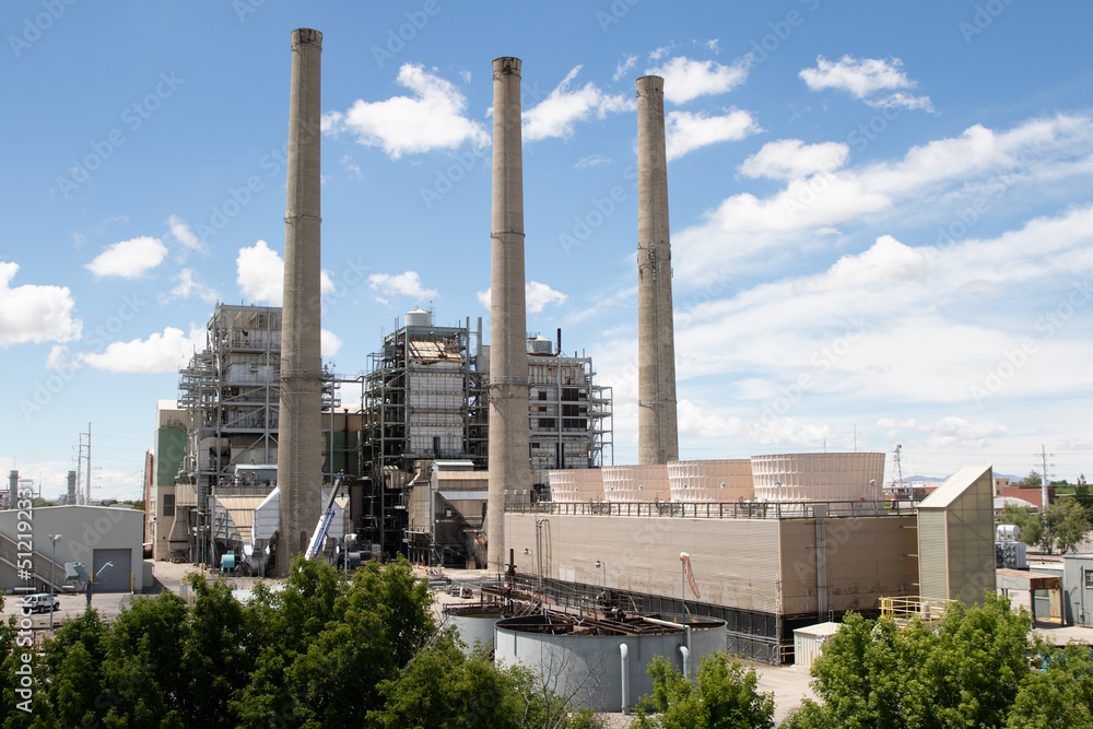 A Power Plant With Several Smoke Stacks in the Daytime A Power Plant With Several Smoke Stacks in the Daytime