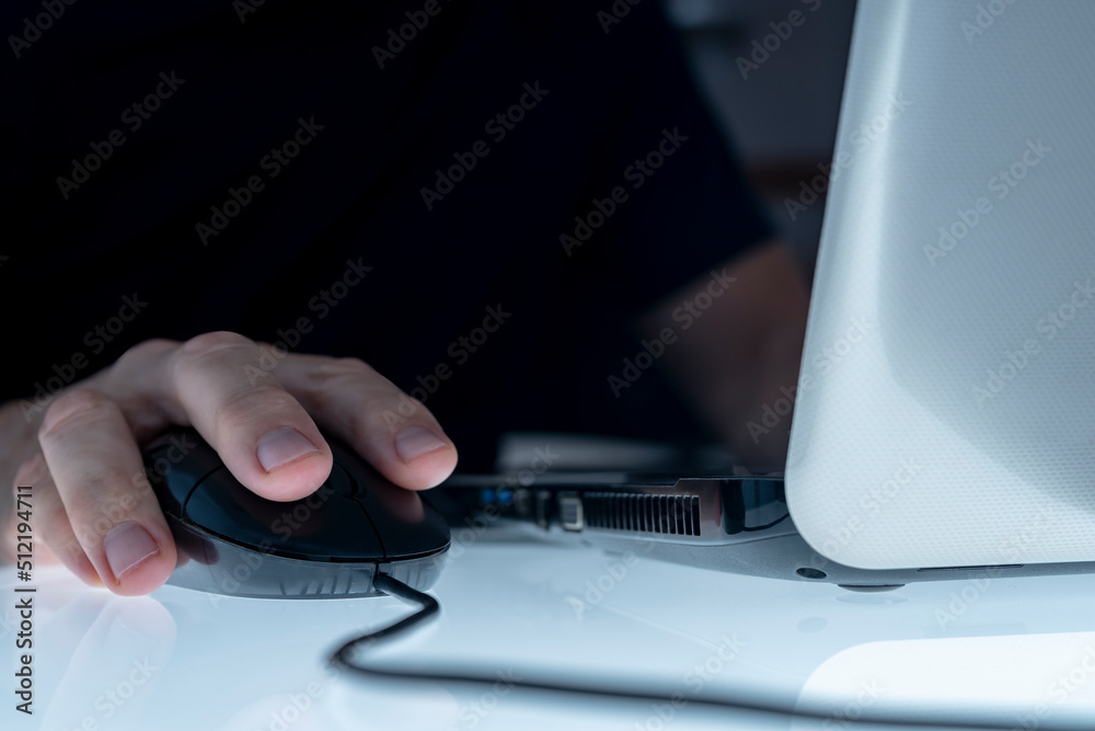 MALE HAND ON THE MOUSE USING LAPTOP. CONCEPT OF CYBER BULLYING, PEDOPHILIA, PEDERASTY, GROOMING, HACKING ATTACK, VIRUS, MALWARE, SHOPPING ADDICTION AND OTHER RISKS ON THE INTERNET. MALE HAND ON THE MOUSE USING LAPTOP. CONCEPT OF CYBER BULLYING, PEDOPHILIA, PEDERASTY, GROOMING, HACKING ATTACK, VIRUS, MALWARE, SHOPPING ADDICTION AND OTHER RISKS ON THE INTERNET.