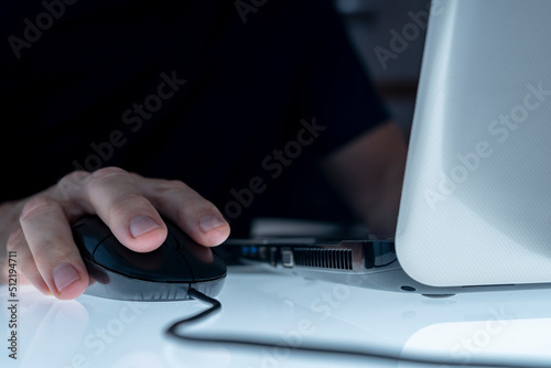Vászonkép MALE HAND ON THE MOUSE USING LAPTOP