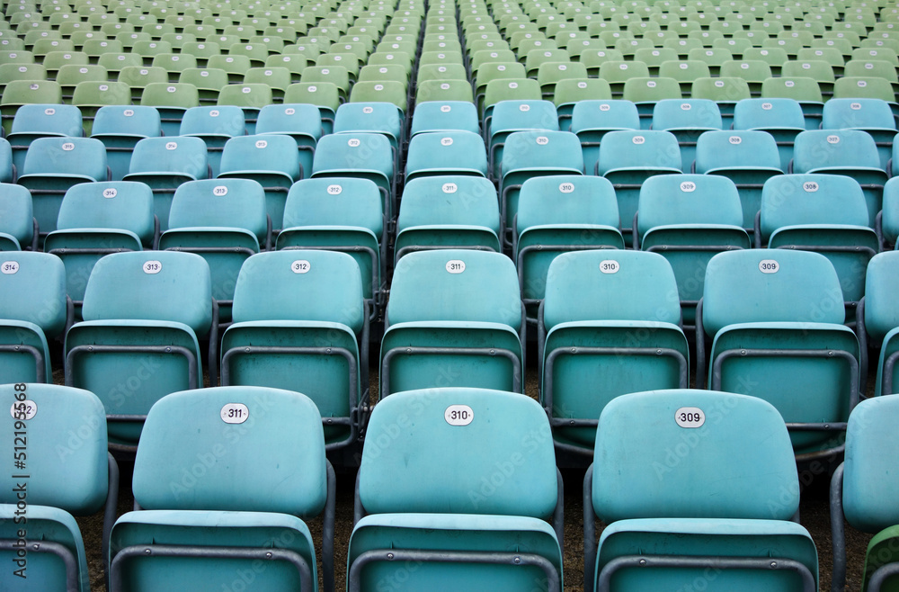 empty seats in a stadium, blue and green empty seats in a stadium, blue and green