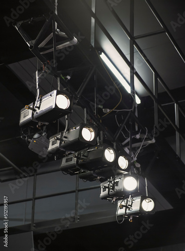 Row of spotlights overhead in theatre photo