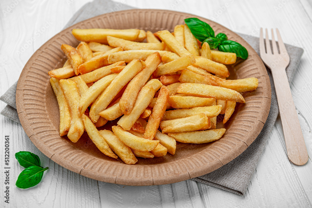 French fries. Fried potatoes on a paper plate.