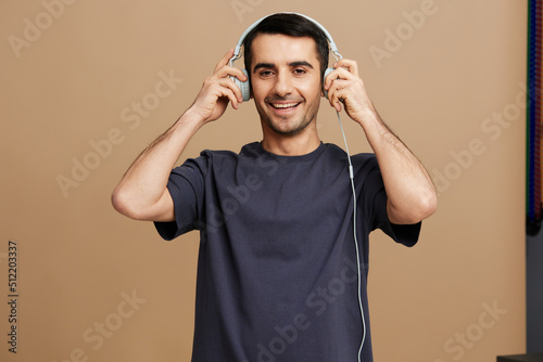 handsome man Listening to music with headphones fun isolated background