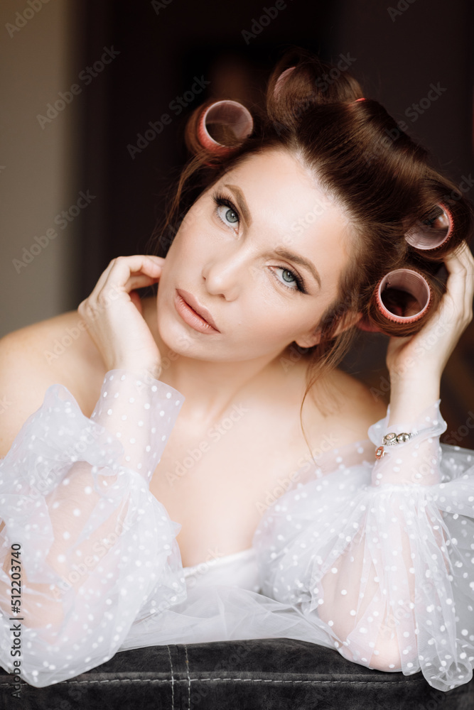 beauty concept. portrait of a beautiful young showy brunette woman with bright pin-up make-up in pink curlers. Studio Shot, Cropped. Facial treatment . Cosmetology , skin care and spa beauty concept. portrait of a beautiful young showy brunette woman with bright pin-up make-up in pink curlers. Studio Shot, Cropped. Facial treatment . Cosmetology , skin care and spa