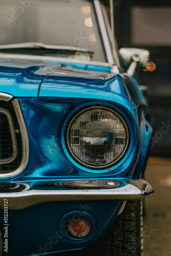 Classic Ford Mustang convertible in blue, parked in the city. Ford mustang is one of the most famous cars in the USA and is an icon of muscle cars in the world.