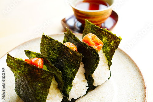Onigiri wrapped in nori with umeboshi on top