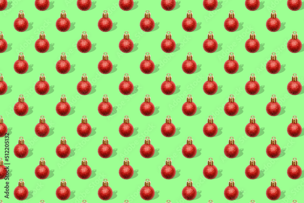 Christmas New Year holiday creative minimal seamless pattern green background with red baubles balls decorations, ornaments, Flat lay, top view