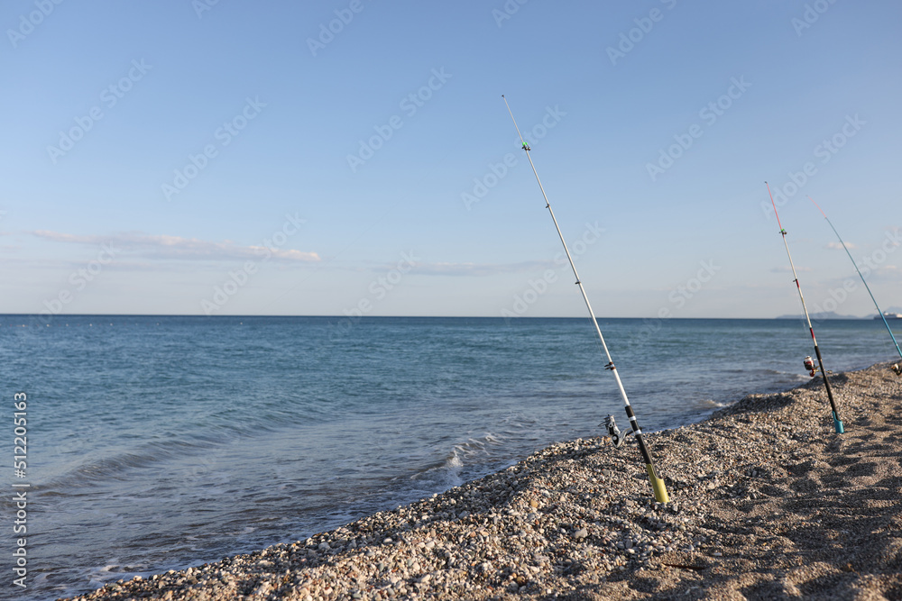 Fishing rods on sea beach, seaside landscape