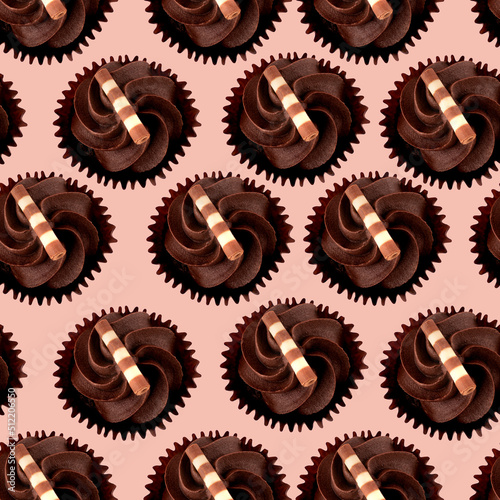 Chocolate cakes muffins on a pink background View above seamless View above seamless