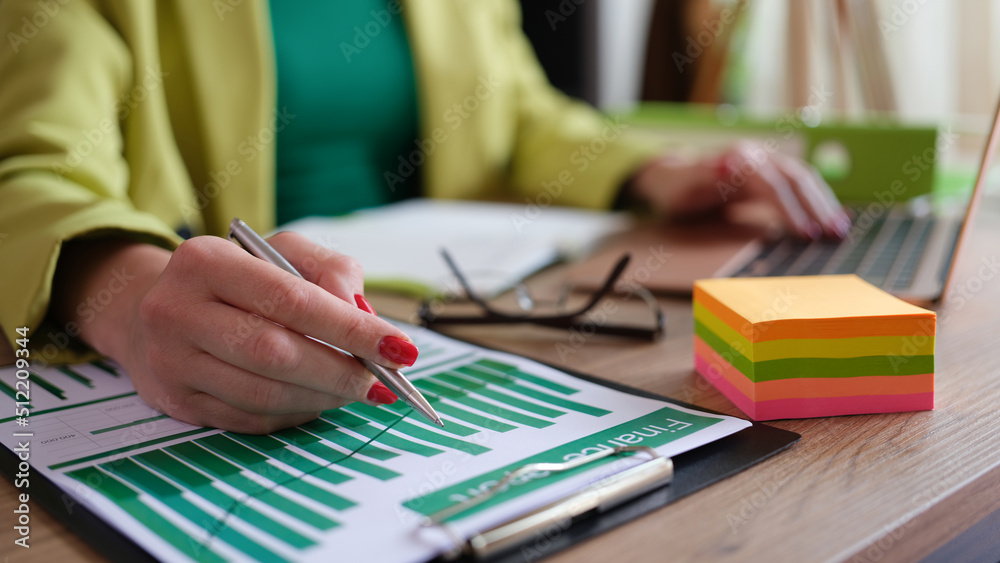 Woman accountant working with financial report and statistics data Woman accountant working with financial report and statistics data