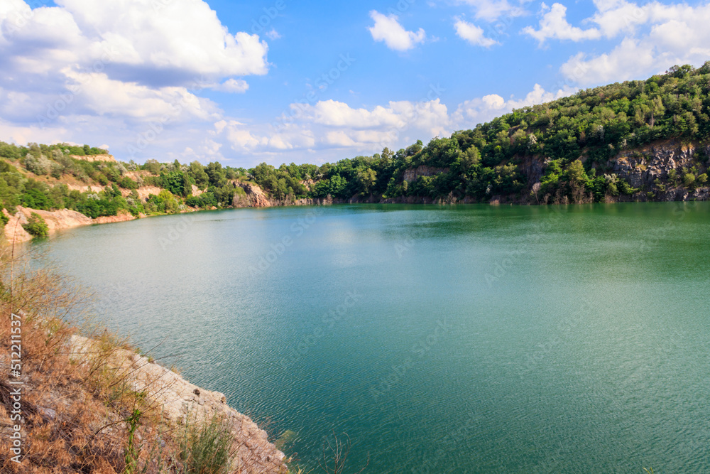 View of the lake at abandoned quarry on summer