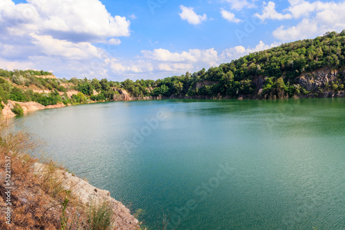 View of the lake at abandoned quarry on summer © olyasolodenko