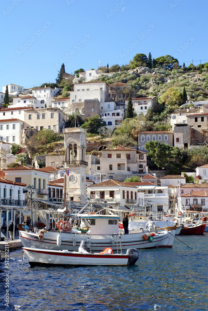 Boats in the harbor, below the city of Hydra, Greece, rising up on a hill above