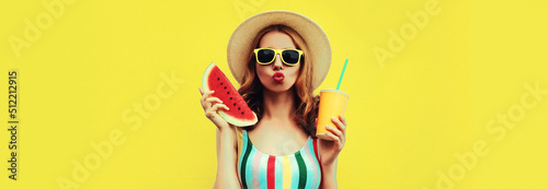 Summer colorful portrait of beautiful young woman blowing her lips with slice of watermelon and cup of juice wearing straw hat on yellow background, blank copy space for advertising text