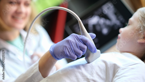 Diagnostic examination of internal organs in children using ultrasound machine photo