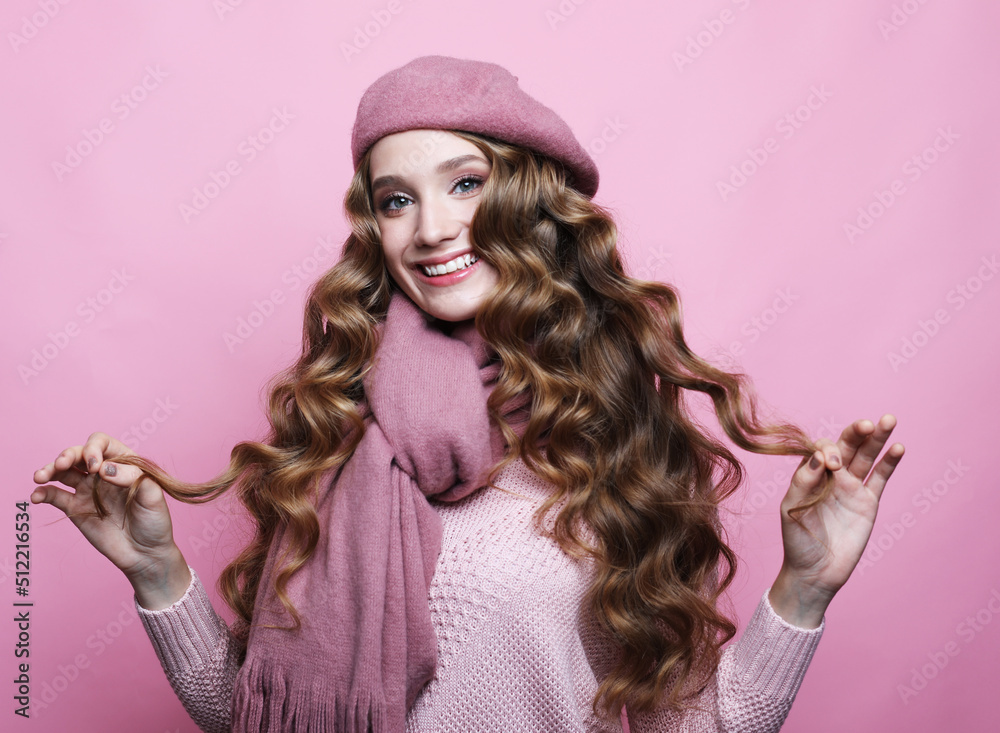 Beautiful young woman with long wavy hair wearing pink beret and scarf Beautiful young woman with long wavy hair wearing pink beret and scarf