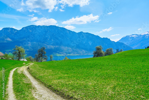 Alpine meadows, mountains, Attersee lake and road near Unterach in Upper Austria
