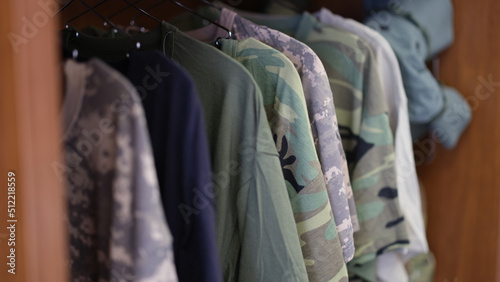 Collection of military uniform tshirts in wardrobe