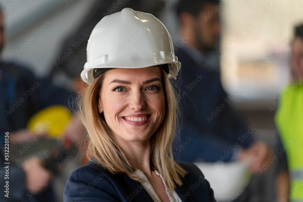 Portrait of female chief engineer in modern industrial factory looking at camera. Portrait of female chief engineer in modern industrial factory looking at camera.