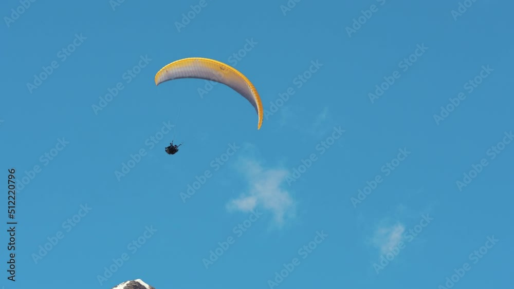 Amazing brave parachuter flying up in the blue sky, watching beautiful mountains. . High quality 4k footage Amazing brave parachuter flying up in the blue sky, watching beautiful mountains. . High quality 4k footage