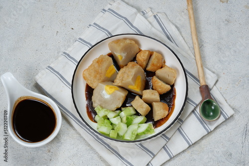 Pempek with cuko sauce in white plate. Pempek or empek-empek is a savoury Indonesian fishcake delicacy, made of fish and tapioca, typically from Palembang, South Sumatera.indonesia photo