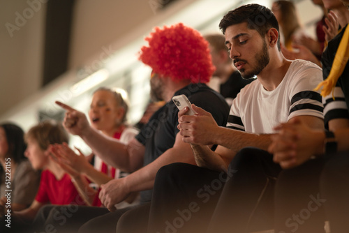 Fototapeta Naklejka Na Ścianę i Meble -  Worried football fans supporting German national team in live soccer match at stadium.