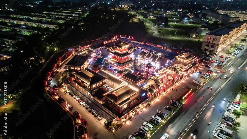 Aerial view of Shanghai old town street decorated with red chinese lanterns at night. Street market in Kelapa Gading, Chinese lanterns on the houses, Jakarta, Indonesia, June 21, 2022 Aerial view of Shanghai old town street decorated with red chinese lanterns at night. Street market in Kelapa Gading, Chinese lanterns on the houses, Jakarta, Indonesia, June 21, 2022