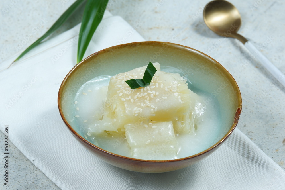 ingkong Thailand or delicious sweet cassava, popular dessert from Thailand, served with coconut milk and pandanus leaves ingkong Thailand or delicious sweet cassava, popular dessert from Thailand, served with coconut milk and pandanus leaves