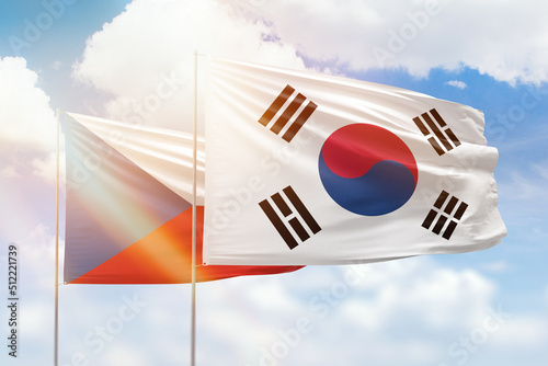 Sunny blue sky and flags of south korea and czechia