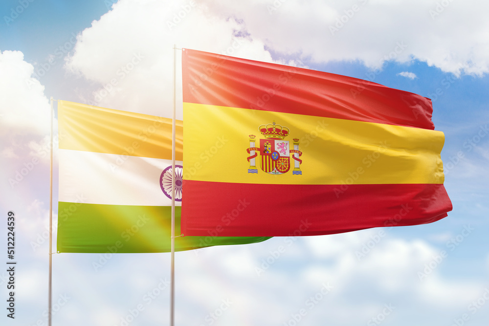 Sunny blue sky and flags of spain and india Sunny blue sky and flags of spain and india