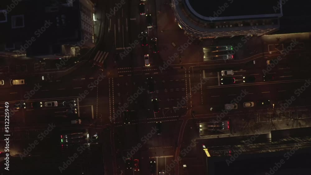 Overhead rotating shot of traffic on road intersection at night. Vehicles stuck at crossroad blocking other vehicles and cyclists. Cologne, Germany Overhead rotating shot of traffic on road intersection at night. Vehicles stuck at crossroad blocking other vehicles and cyclists. Cologne, Germany