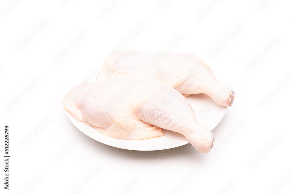 Raw chicken thighs in white dish isolated on white Raw chicken thighs in white dish isolated on white