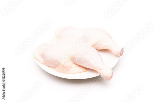 Raw chicken thighs in white dish isolated on white