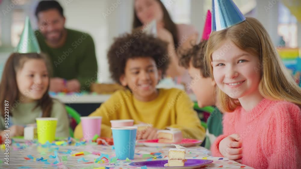 Portrait of girl sitting at table for party celebrating birthday with piece of birthday cake - shot in slow motion Portrait of girl sitting at table for party celebrating birthday with piece of birthday cake - shot in slow motion