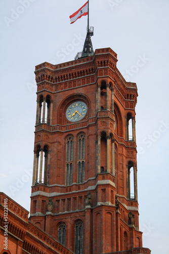 View of tower and clock of Rotes Rathaus in summer, the famous red town hall of Berlin with clouds in blue sky background. photo