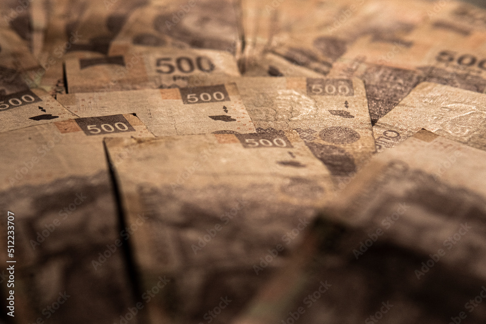 Money piled on a table, mexican peso currency Money piled on a table, mexican peso currency