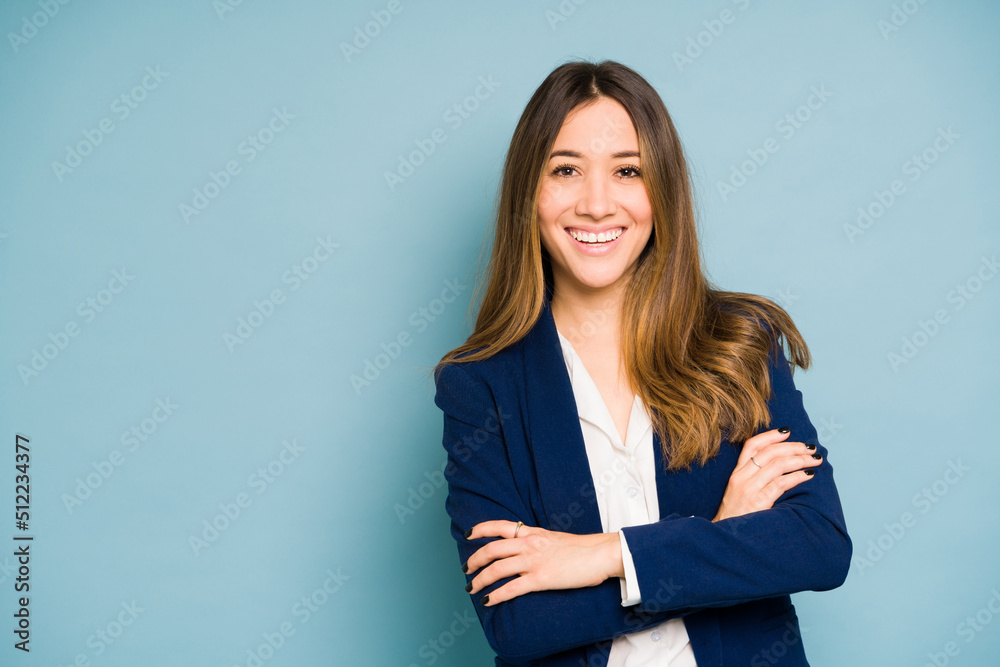 Happy businesswoman in a studio with her arms crossed Happy businesswoman in a studio with her arms crossed
