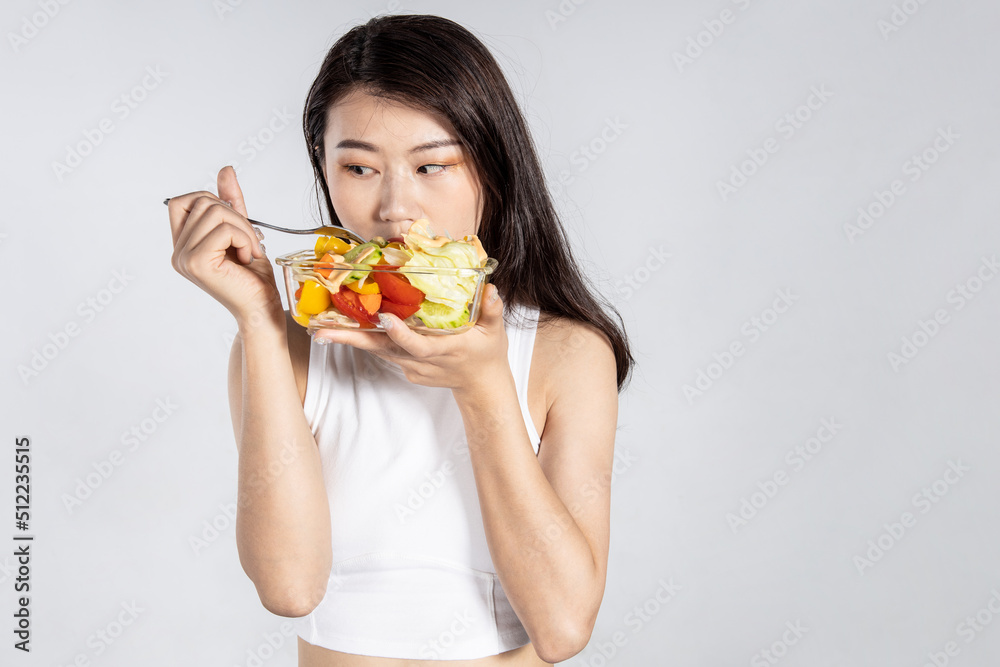 A sporty, healthy beauty with a green salad A sporty, healthy beauty with a green salad