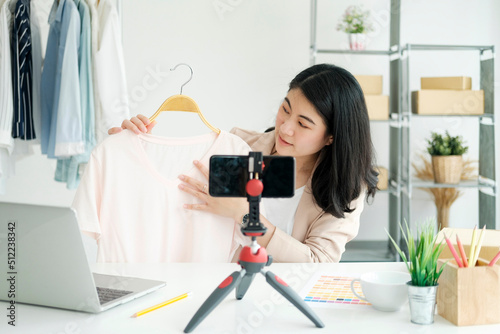 Businesswoman giving important pieces of advice while streaming video for women's clothing.