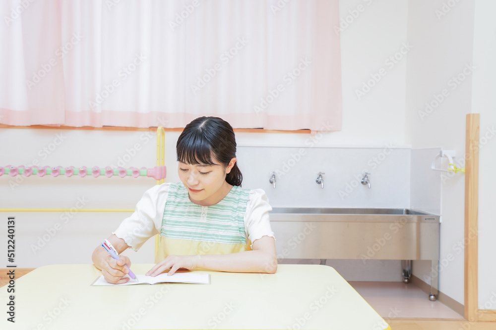 Young kindergarten teacher working at office Young kindergarten teacher working at office