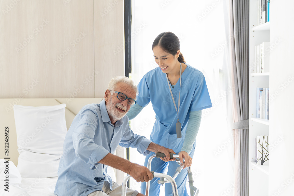 Female nurse caring senior man using walker in rehab center. Caregiver helping caucasian elderly man using walker at nursing home. Female nurse caring senior man using walker in rehab center. Caregiver helping caucasian elderly man using walker at nursing home.