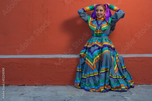 Young Mexican woman prepares her dress and makeup for a traditional Mexican dance